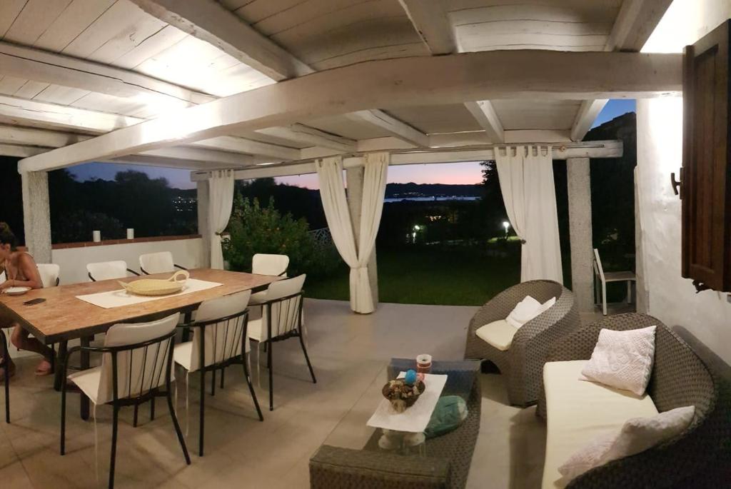 a living room with a table and chairs at Villa Alba in Cala Bitta