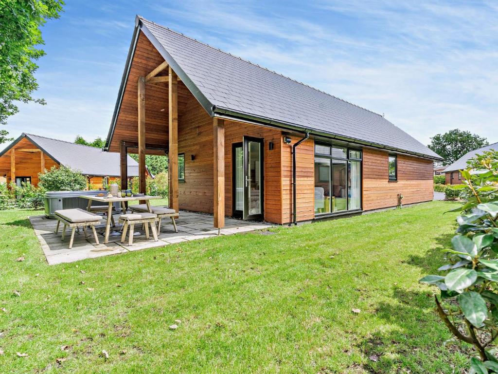 a wooden house with a picnic table in a yard at 2 Bed in Gower 91724 