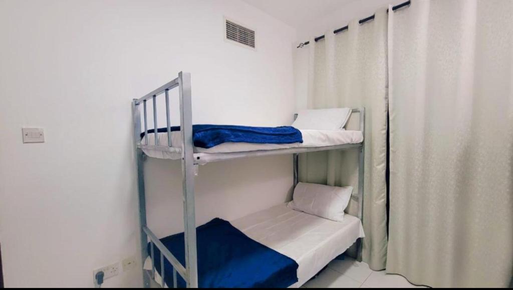 a couple of bunk beds in a room at DXB HOSTEL Near ADCB Metro Station in Dubai
