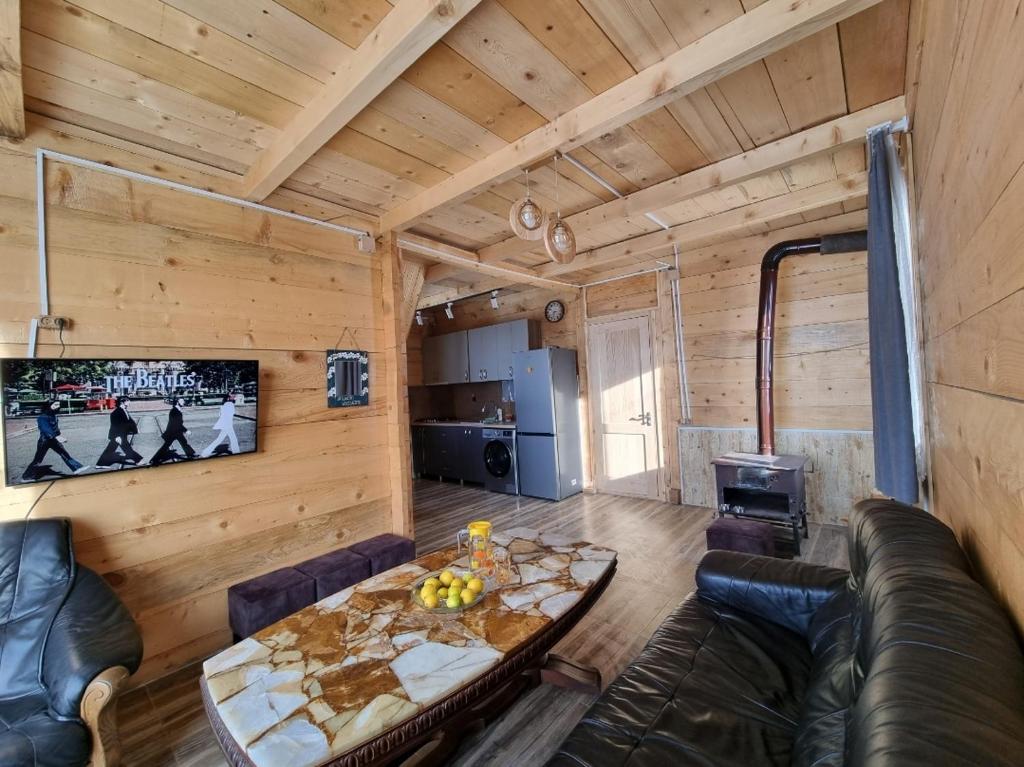 a living room with a table and a couch at Cottage SuBree on Goderdzi in Goderdzi