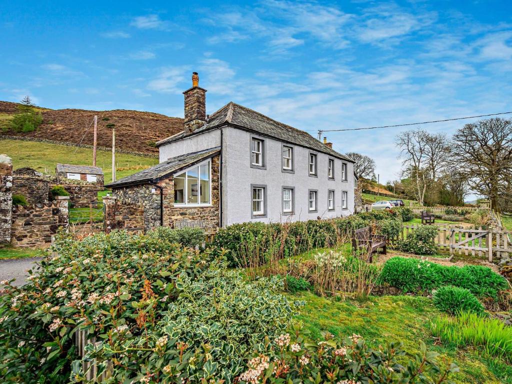 an old stone house in the middle of a garden at 1 Bed in Matterdale 91812 in Dockray