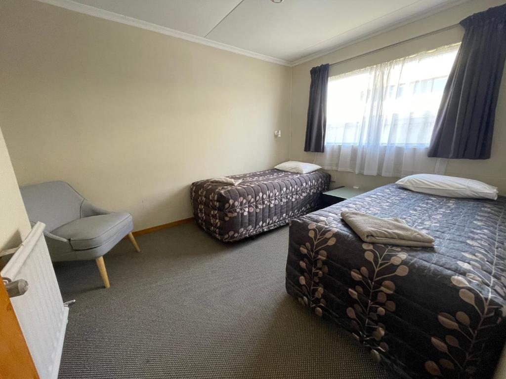 Postel nebo postele na pokoji v ubytování Alexandra Motor Lodge NZ