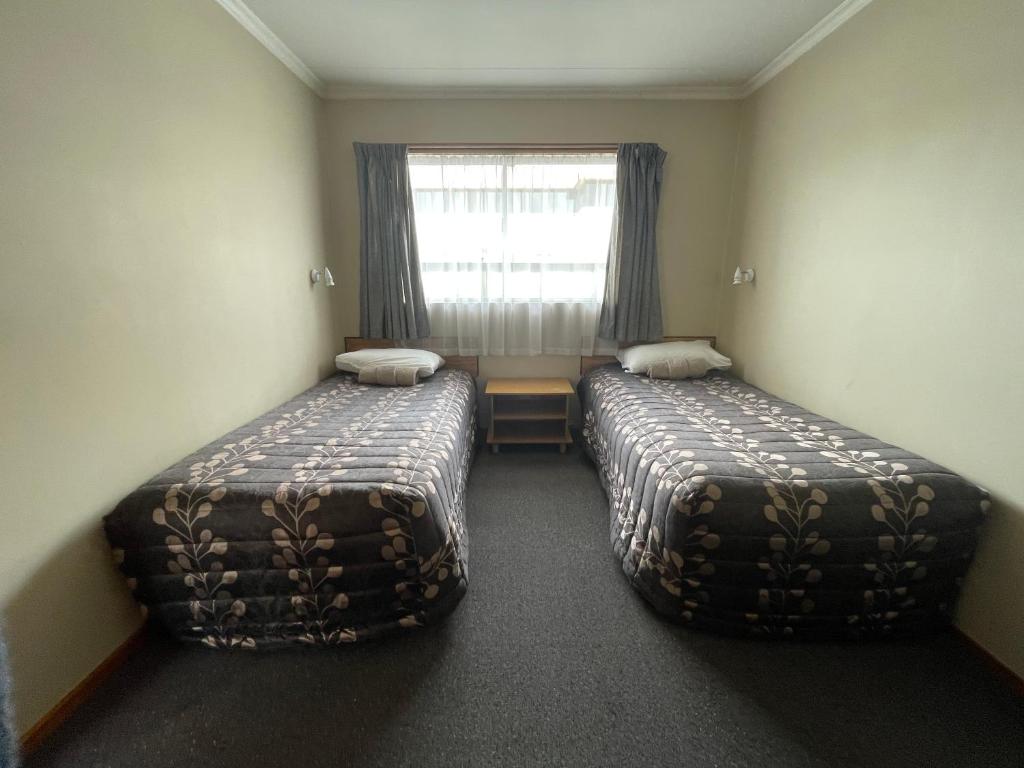 Postel nebo postele na pokoji v ubytování Alexandra Motor Lodge NZ