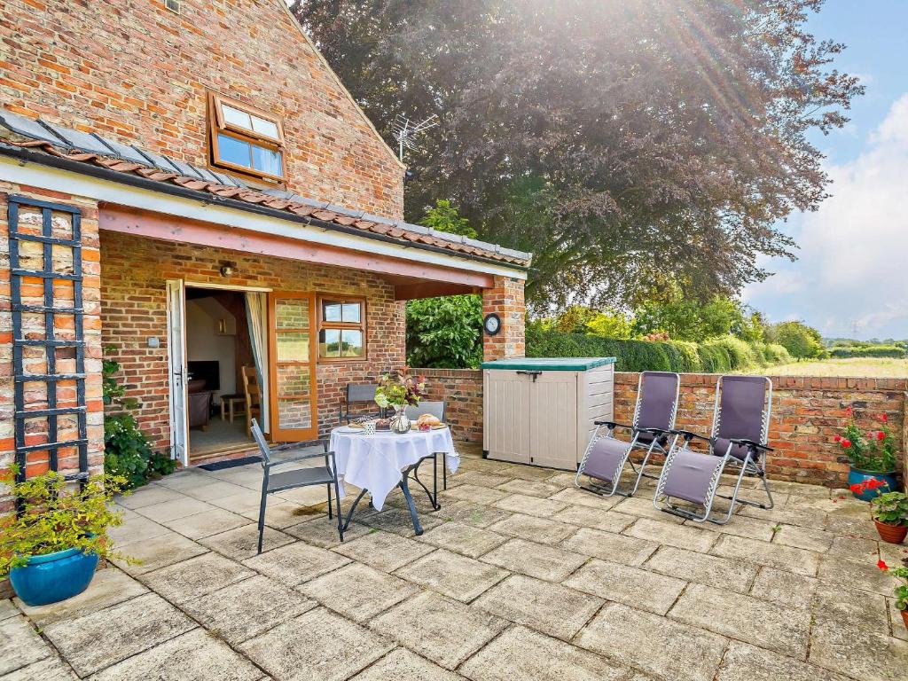 a patio with a table and chairs in front of a building at 1 bed in Stamford Bridge 92093 in High Catton