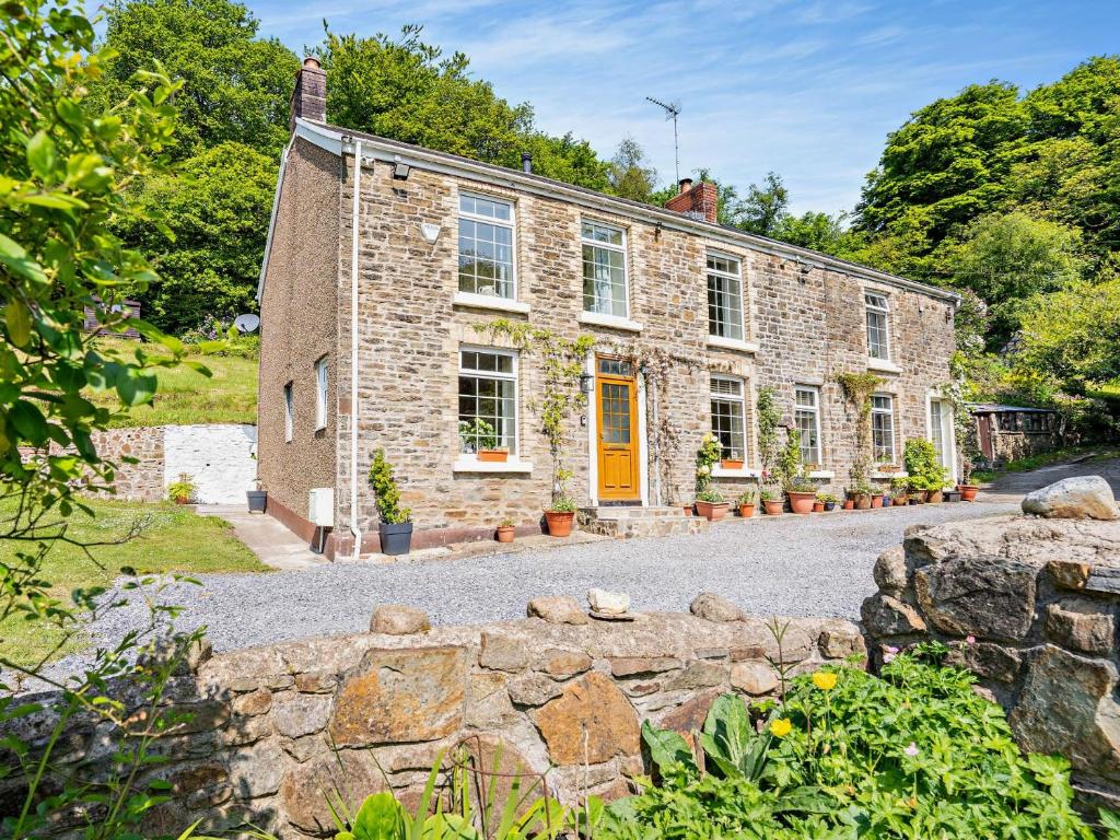 an exterior view of a stone house at 3 Bed in Swansea 92059 in Sketty