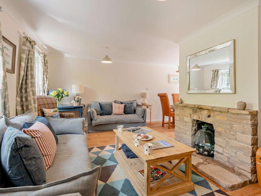 a living room with a couch and a fireplace at 3 Bed in West Lulworth 92106 in West Lulworth