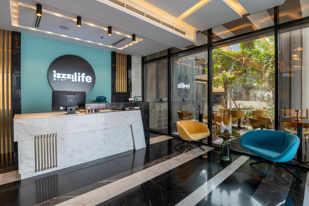 a lobby of a hotel with a table and chairs at izzzilife Mint in Dubai