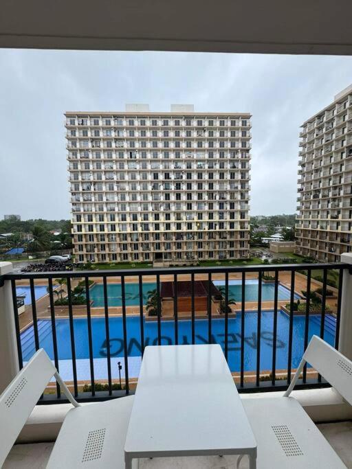 a balcony with a view of a large building at Ross' Cosy Corner in Lapu Lapu City