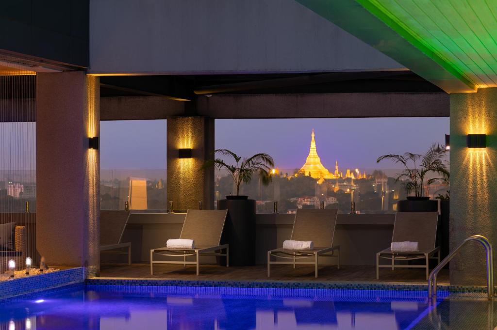 a swimming pool with a view of a building at Yangon Thanlwin Hotel in Yangon