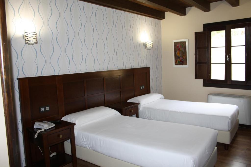 Postel nebo postele na pokoji v ubytování Hotel Rural El Reundu