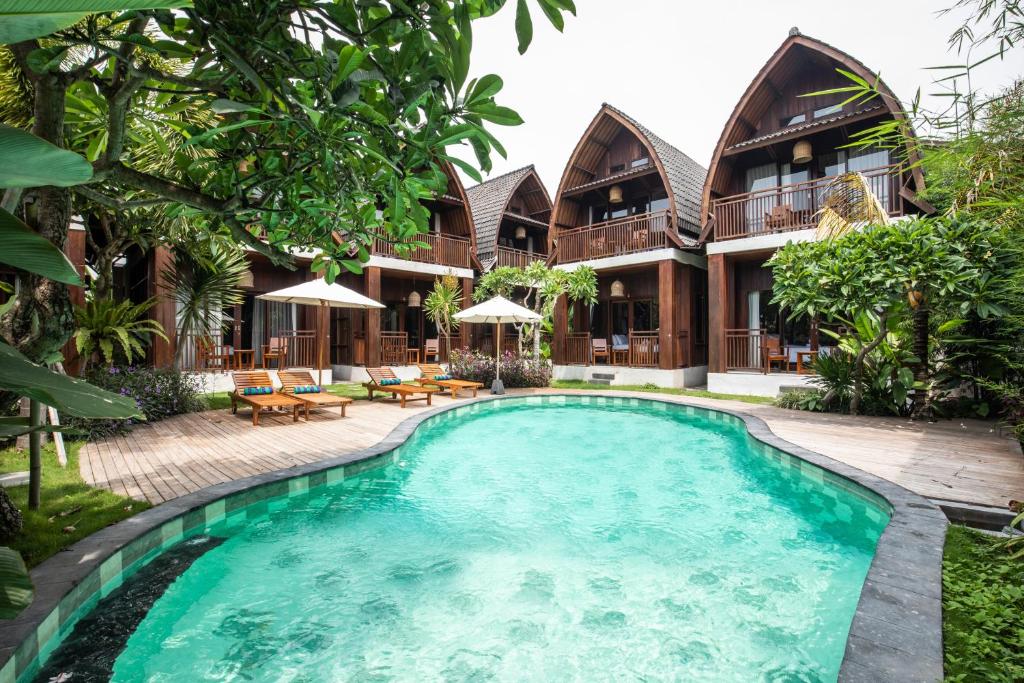 a swimming pool in front of a house at DADEKA Canggu in Canggu