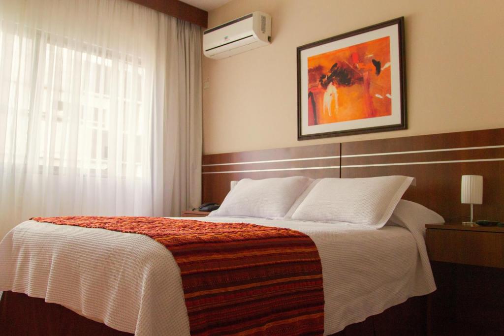 Postel nebo postele na pokoji v ubytování Hotel America