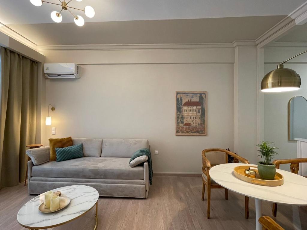 a living room with a couch and a table at Syntagma Hideaway Luxury Apt in Athens