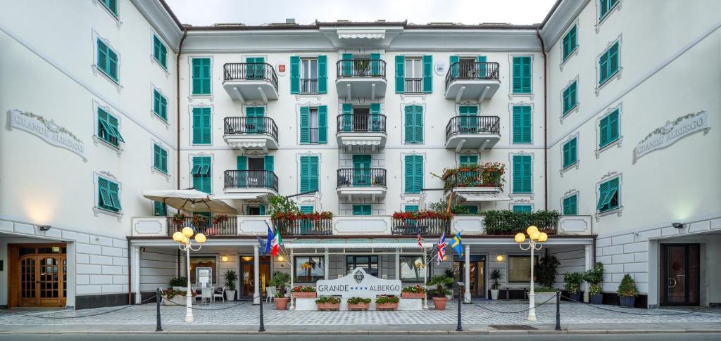 a large white building with green shutters at Grande Albergo in Sestri Levante