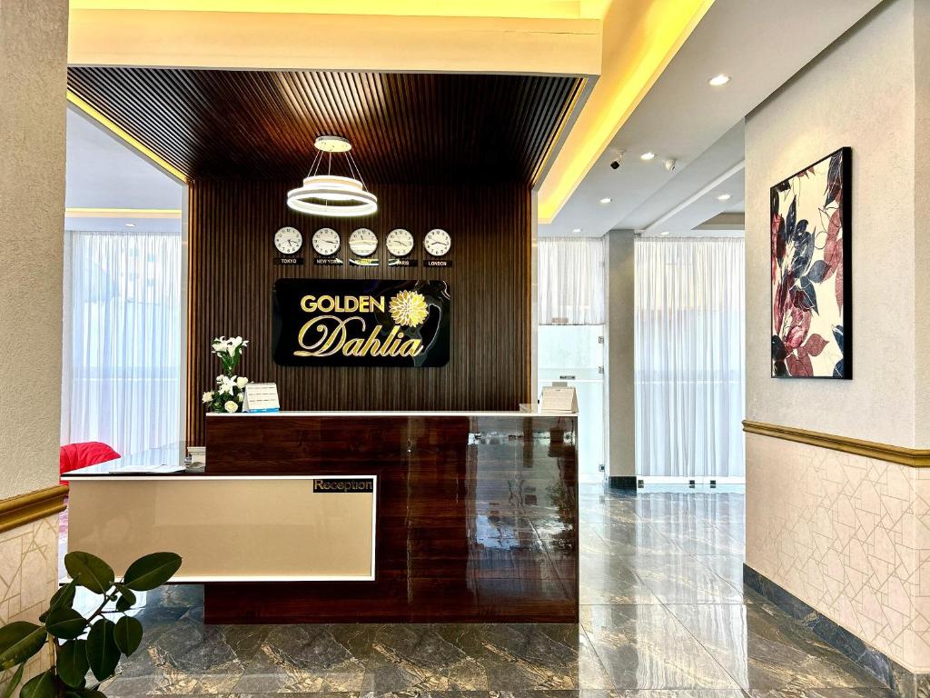 a lobby with a colgate sign on the wall at Golden Dahlia Fintas in Kuwait