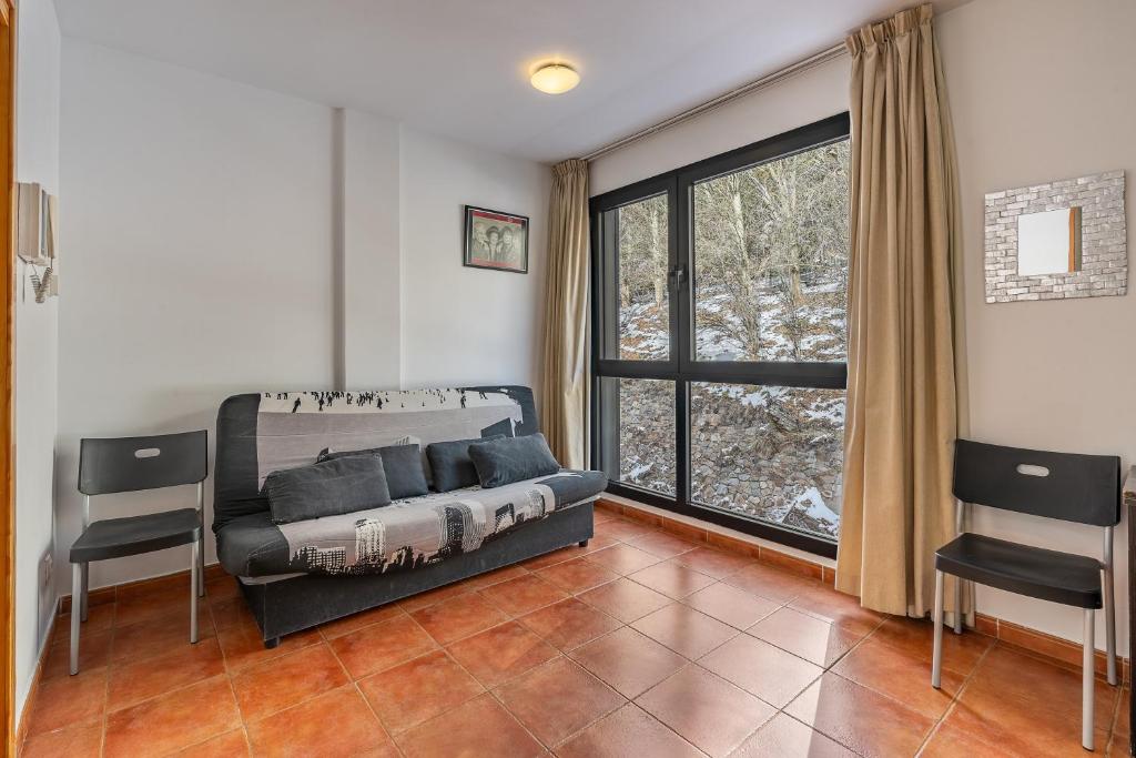 een slaapkamer met een bed en een groot raam bij Monte Gorbea 7 I in Sierra Nevada