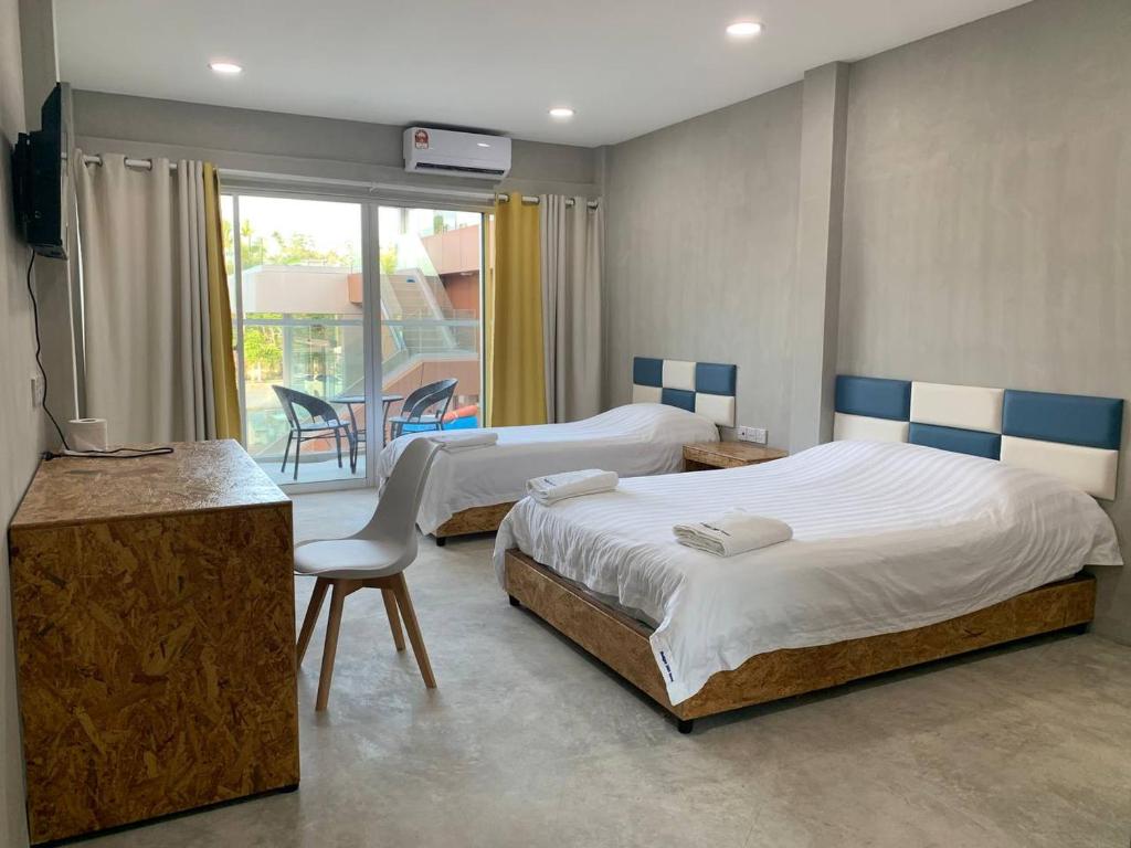 a hotel room with two beds and a balcony at 365 View Point Resort in Kaki Bukit