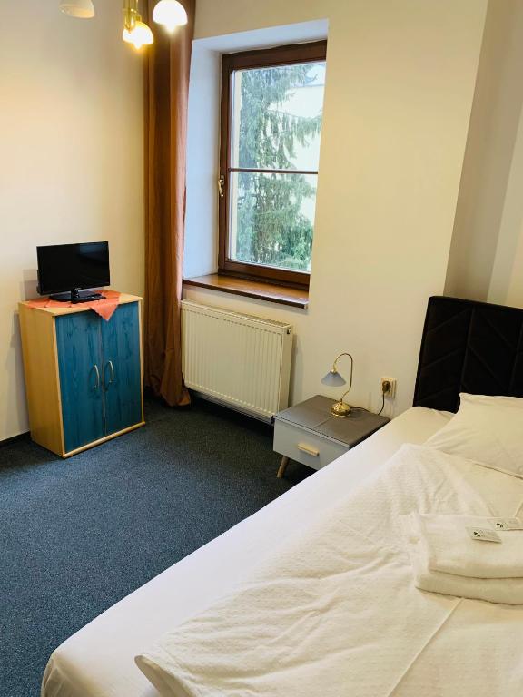 Postel nebo postele na pokoji v ubytování Hotel Slovan