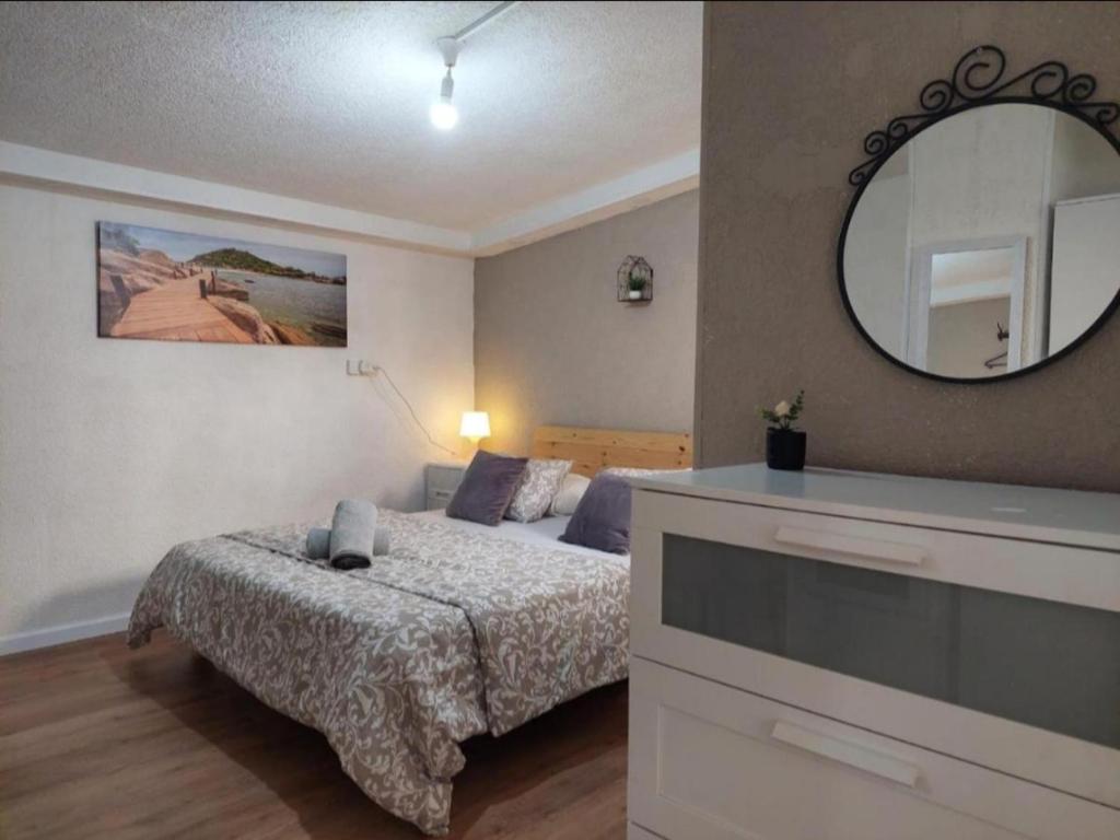 a bedroom with a bed and a large mirror at Amazing garden apartment in Haifa in Haifa