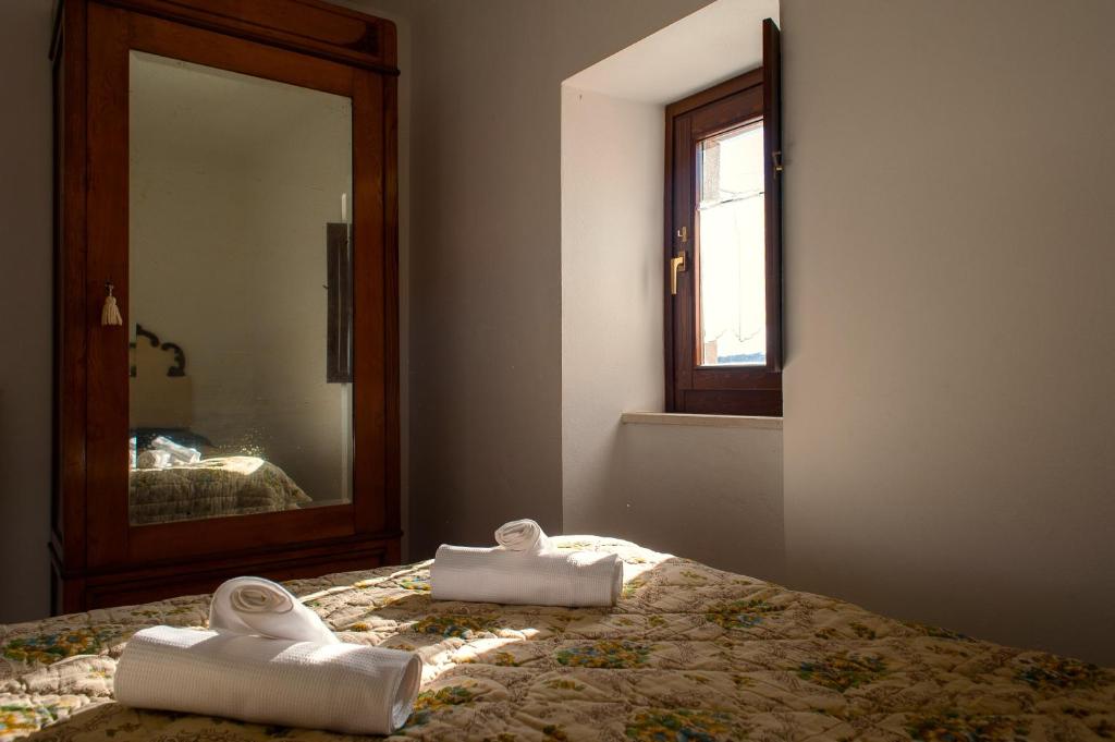a bedroom with a bed with two towels on it at Casa Ladyhawke in Santo Stefano di Sessanio