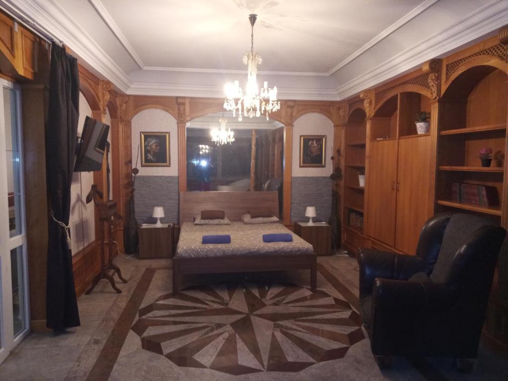 a bedroom with a bed and a chandelier at Villa-ház in Budapest