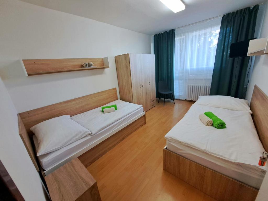 a hotel room with two beds and a window at Školský internát Medická 2 in Košice