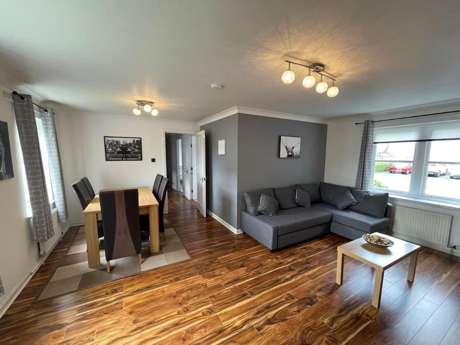 a living room with a couch and a table at 2 Bedroom Apartment near Glasgow Airport in Renfrew