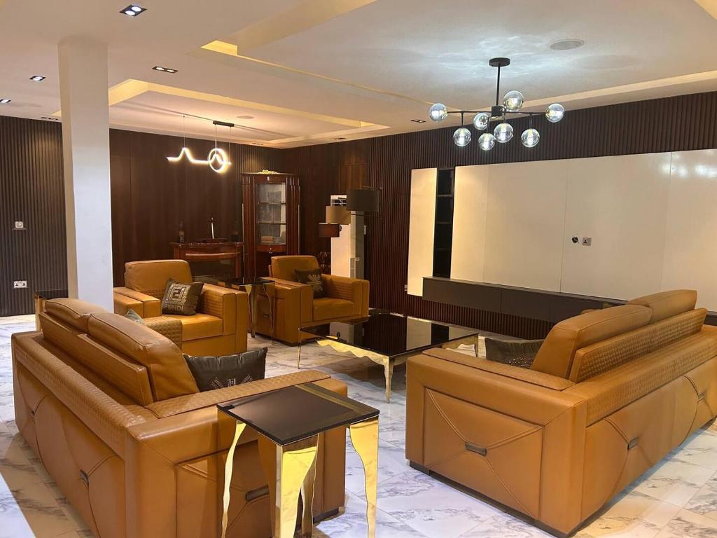 a lobby with couches and a projection screen at Skyloft Suite in Lagos