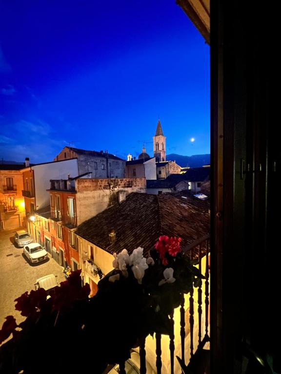 a view of a city at night from a balcony at Regina d’Aragona casa vacanze in Sulmona