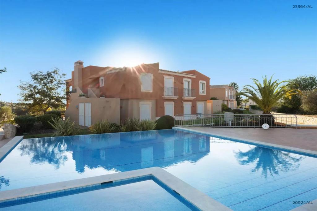 a large swimming pool in front of a house at Pestana Carvoeiro Golfe - AL in Carvoeiro