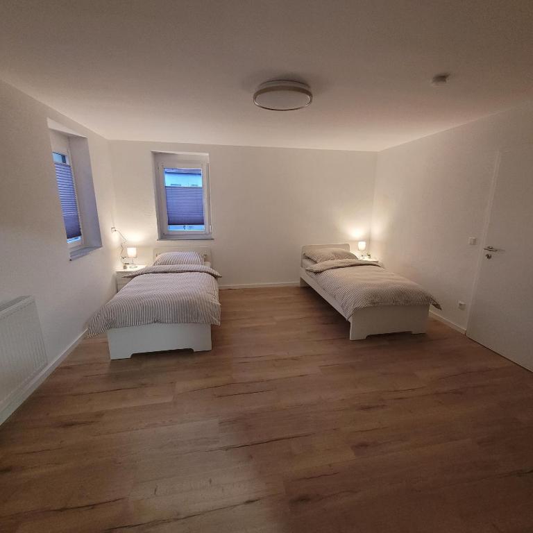 Ένα ή περισσότερα κρεβάτια σε δωμάτιο στο Apartments am Kochertal