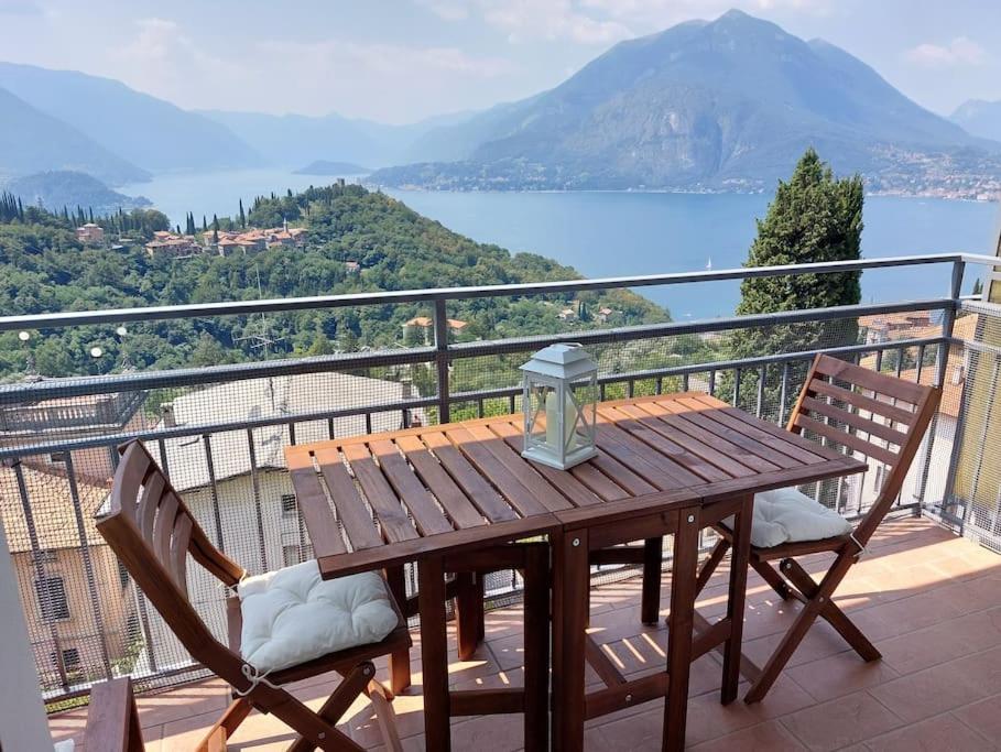 a wooden table and two chairs on a balcony at Sunset House Perledo in Perledo