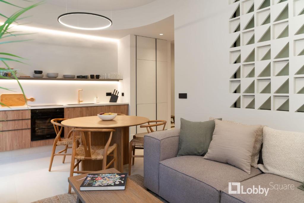 a living room with a couch and a table at Muse Apartment by LobbySquare in Athens
