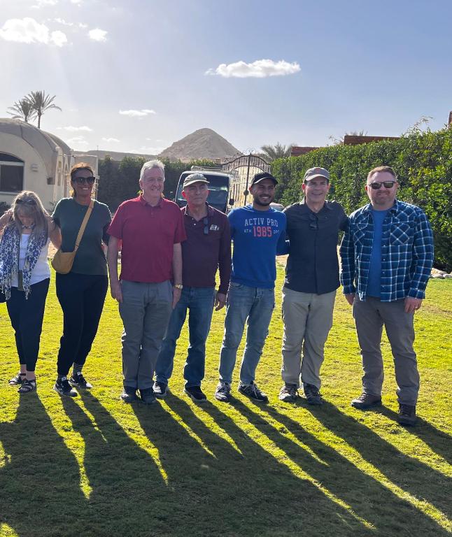 a group of people standing in the grass at Sahure Pyramid View Inn in Cairo
