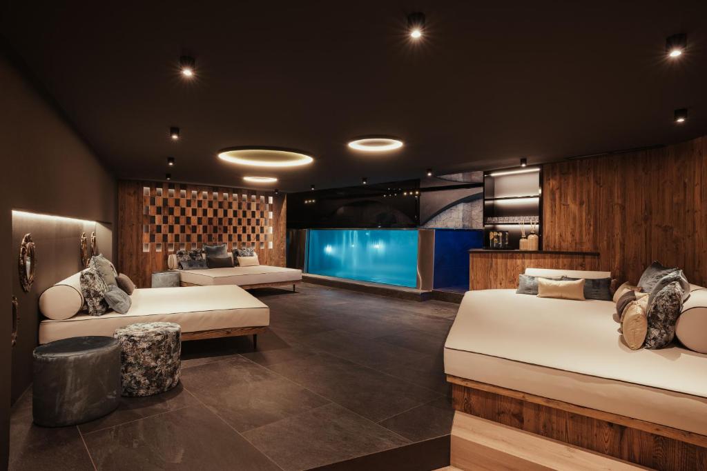 a bedroom with two beds and a large aquarium at Luxury Chalet P in Ortisei