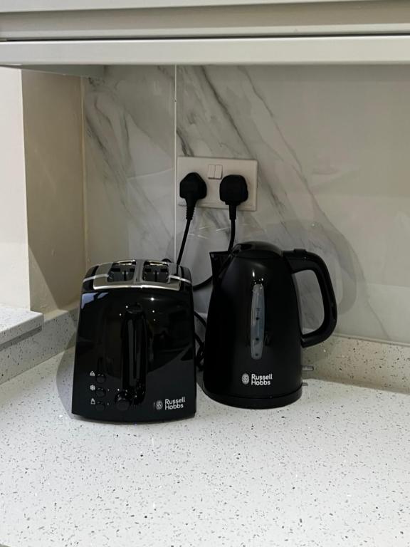 two toasters sitting on a counter next to each other at Dralda House in Buckinghamshire