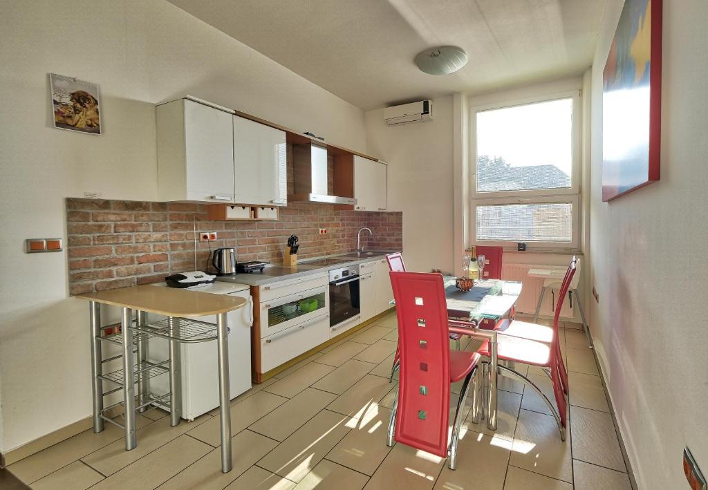 a kitchen with a counter and a table with chairs at Apartment Ken near Terme Paradiso in Dobova