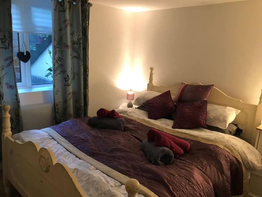 a bedroom with a large bed with pillows and a lamp at The Old Post Office, Knaresborough in Knaresborough