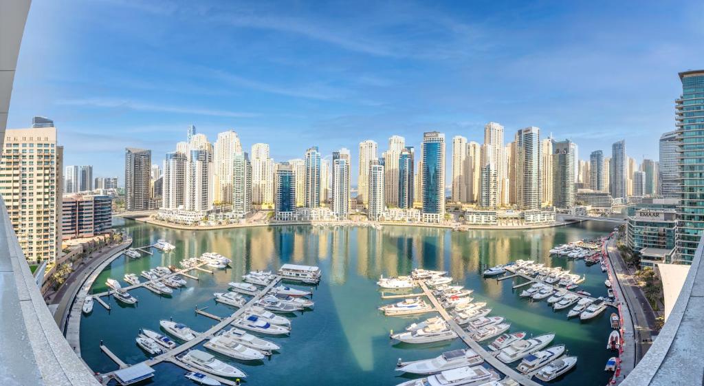 a group of boats in a harbor in a city at Elegant family apartment in Marina Vida Residence in Dubai