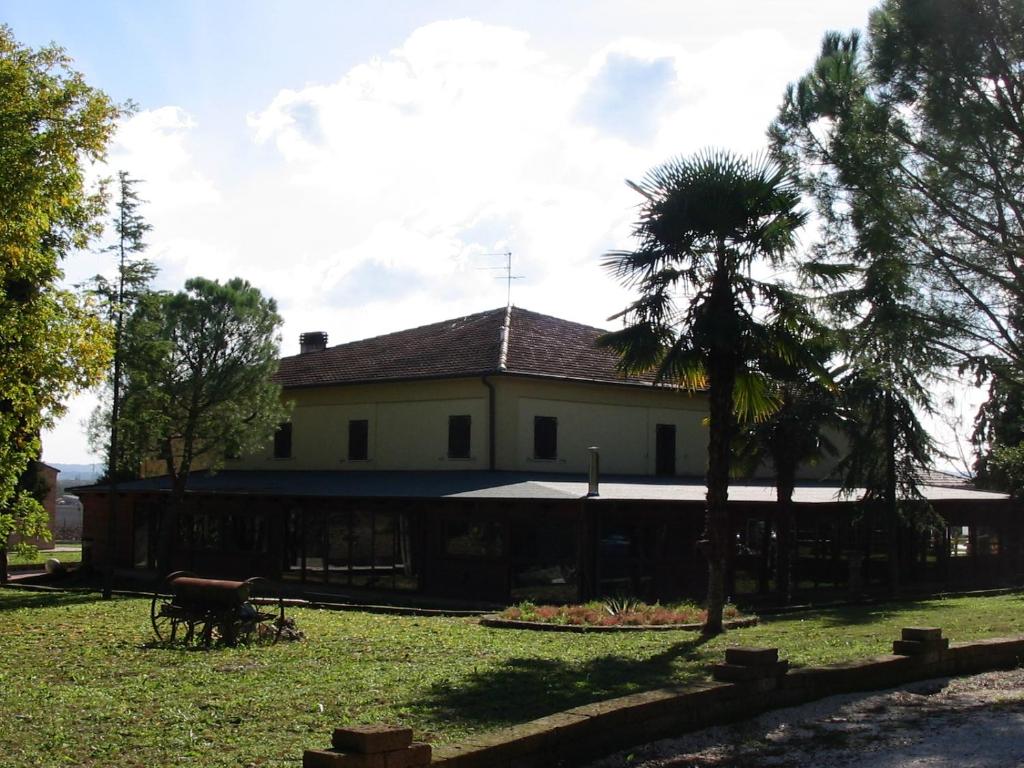 a house with a palm tree in front of it at Casale del Gufo in Chiaravalle