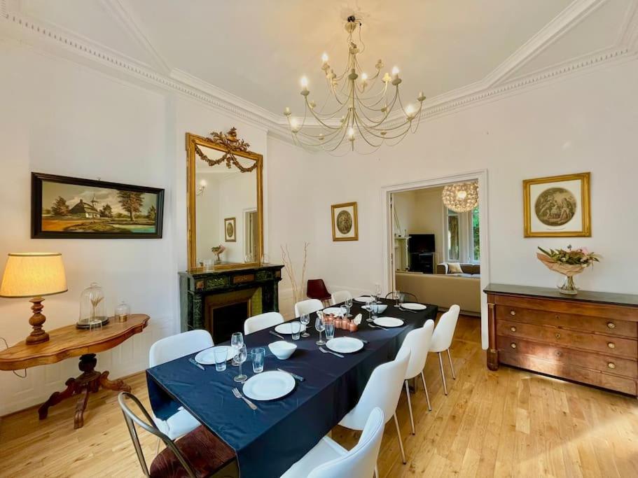 una sala da pranzo con tavolo blu e sedie bianche di L’Hôtel Particulier des Anges a Reims