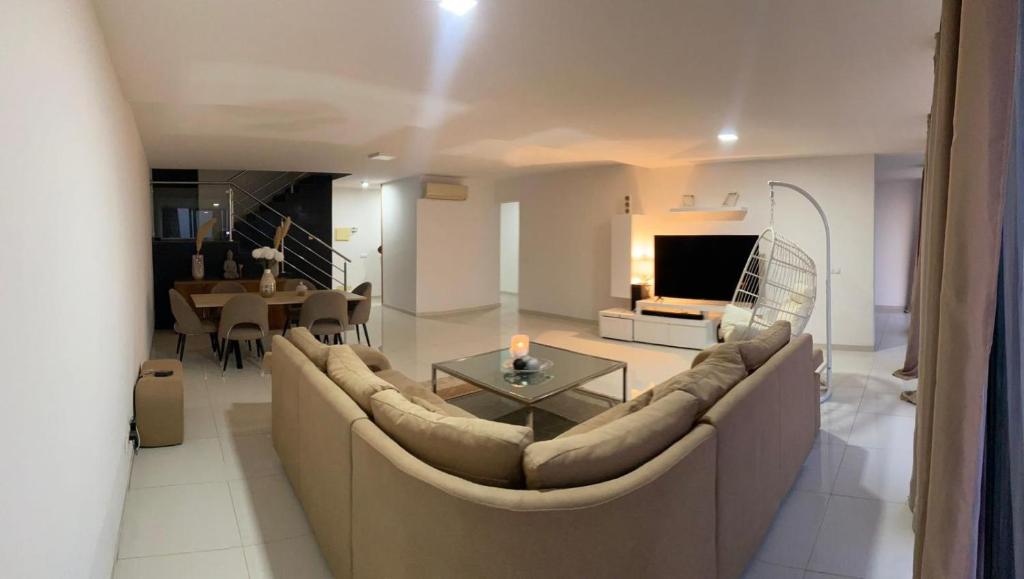 a living room with a large couch and a table at NICE DUPLEX, PRAIA in Praia