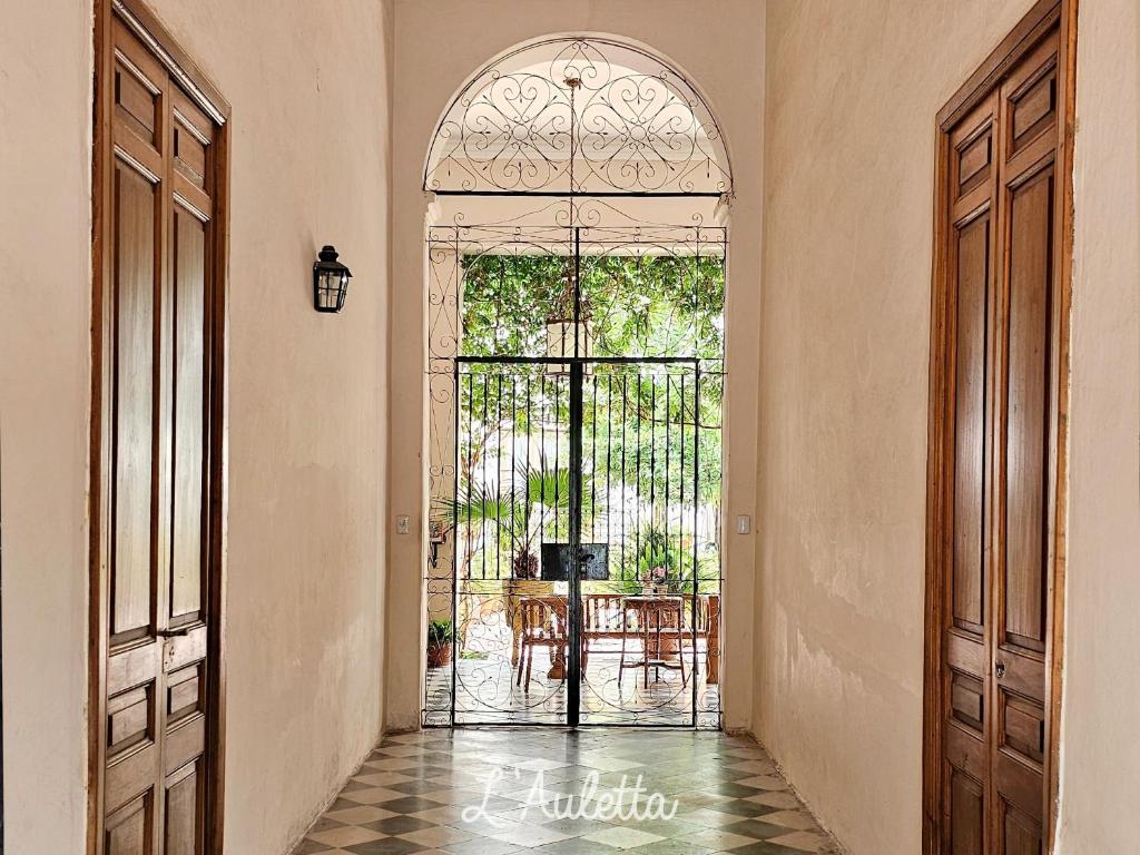 a hallway with an open door to a dining room at L' Auletta in Cafayate