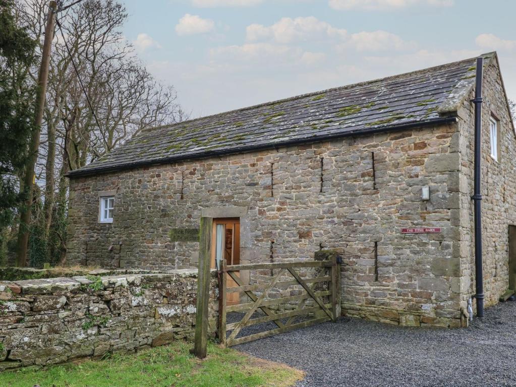 an old stone building with a wooden door at The Tithe Barn in Barnard Castle