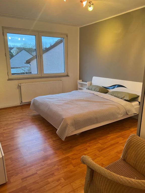 a bedroom with a large bed and two windows at Gemütliche Ferien-/Monteurenwohnung in Herne in Herne