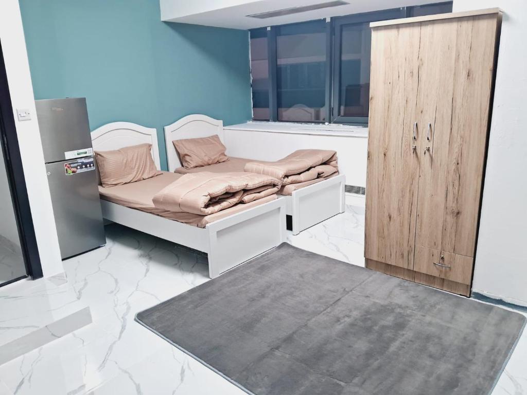 a room with a bed and a wooden door at Urban Lifestyle in Dubai