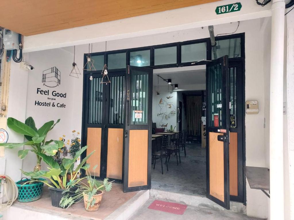 an open door of a restaurant with a table and chairs at Feel good pinklao in Bangkok