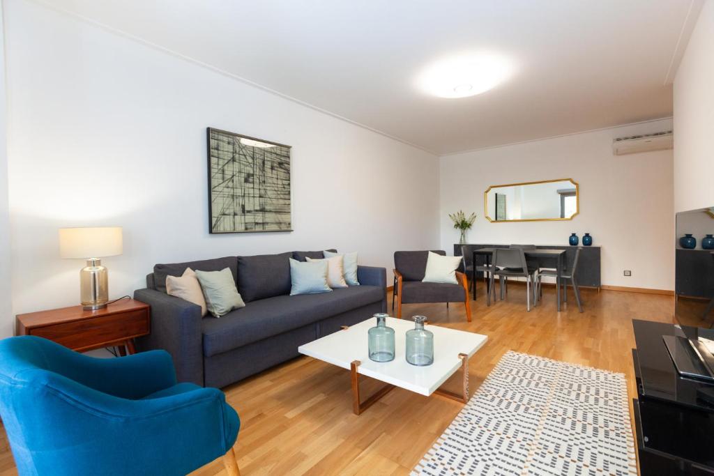 a living room with a couch and a table at Apartamento Lisboa Sete Rios in Lisbon