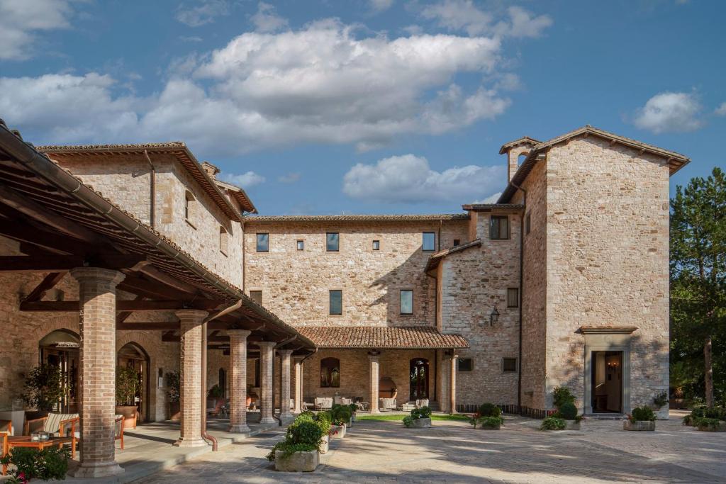 una vista exterior de un gran edificio de piedra en Park Hotel Ai Cappuccini, en Gubbio