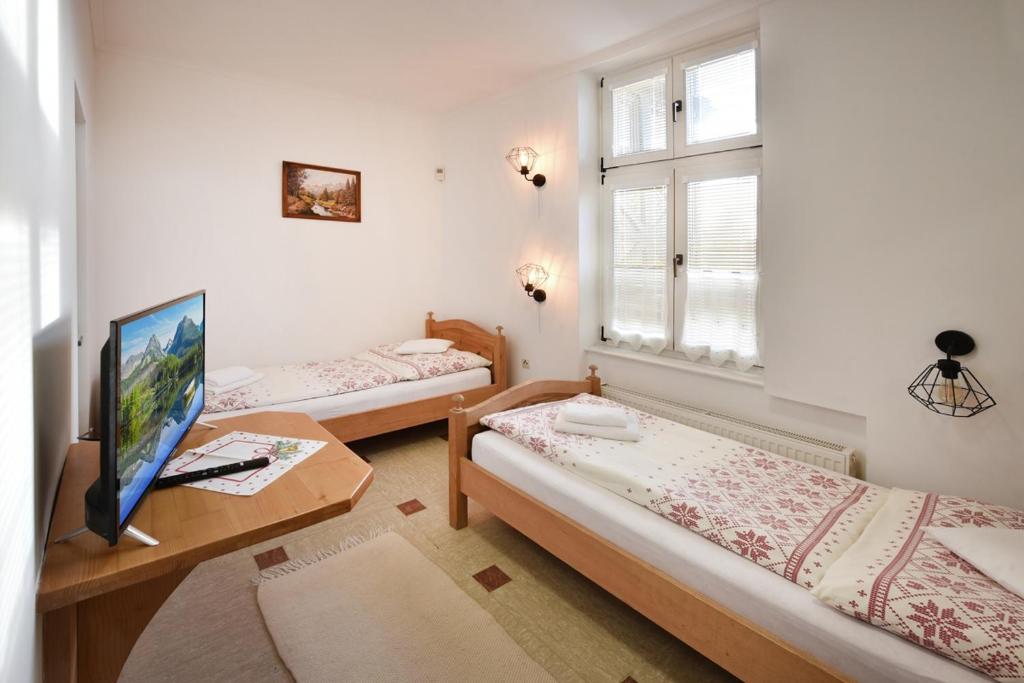 A bed or beds in a room at Vila Aurora - Vysoke Tatry